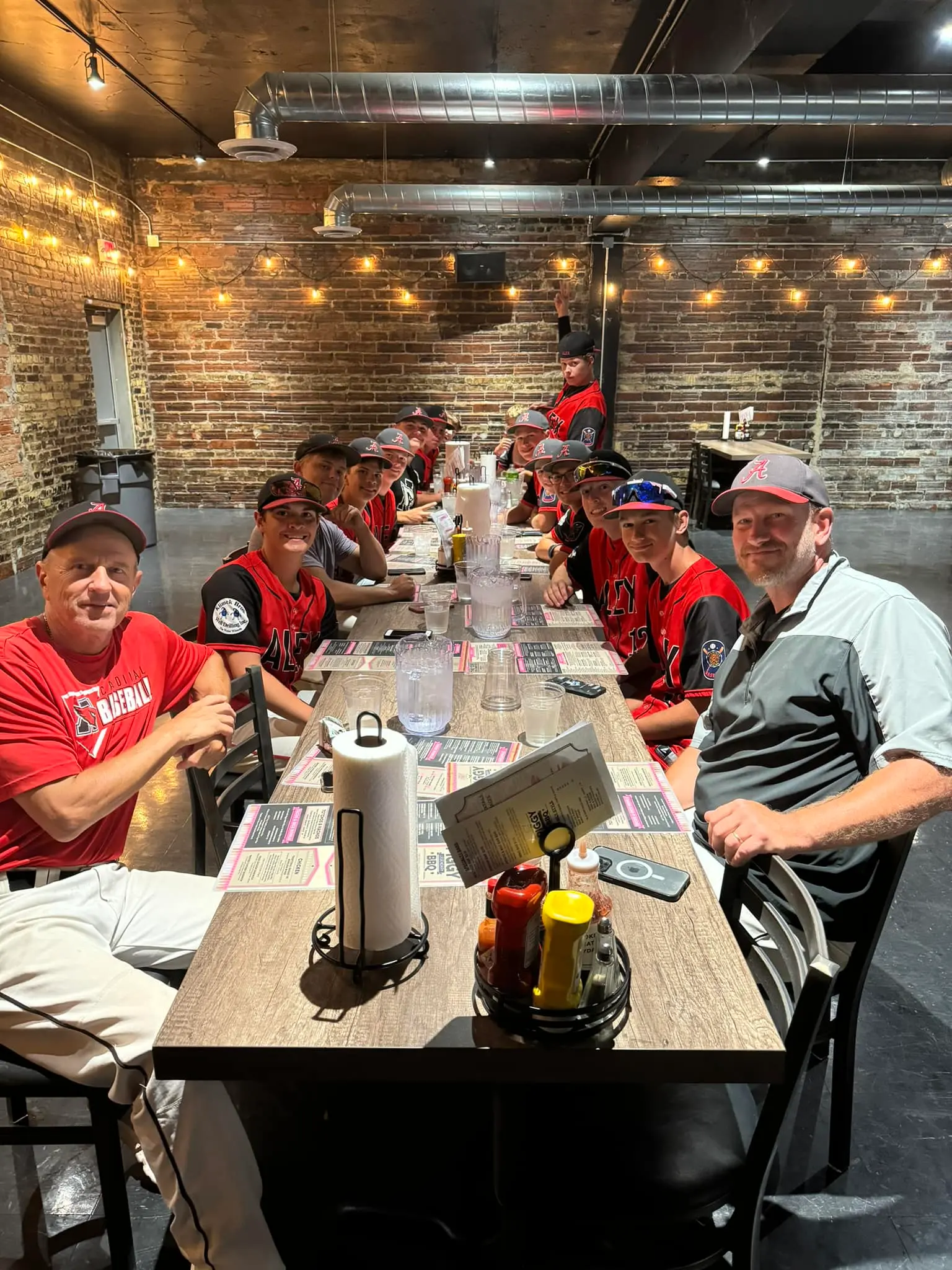 Baseball team in event room at The Piggy BBQ TRF